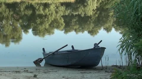 Empty boat at riverbank Stock Footage 12496641