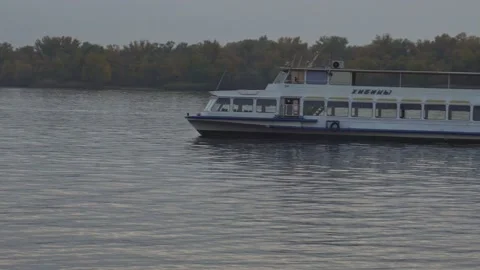 Empty boat swims to the pier on the river in the evening in the city Stock Footage 141991352