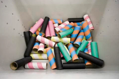 Empty bobbins in plastic container in weaving mill Stock Photos