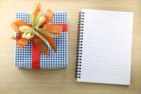 Empty Book and blue gift box on the wooden floor. Stock Photos