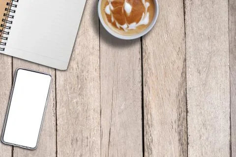 Empty book and mock up smart phone and coffee on desk, copy space for backgro 库存照片