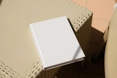 Empty book mockup on plastic table tile floor in the room, shadow overlay Stock Photos