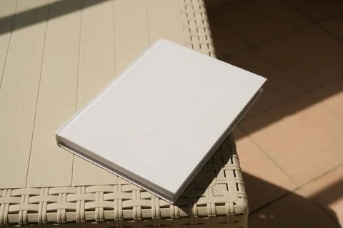 Empty book mockup on plastic table tile floor in the room, shadow overlay Stock Photos
