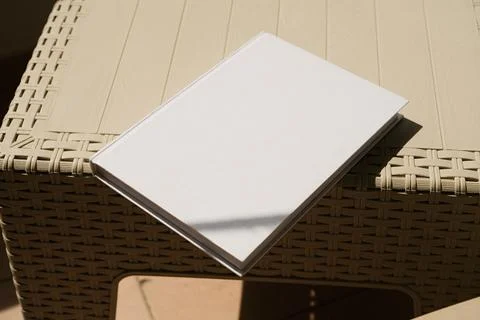 Empty book mockup on plastic table tile floor in the room, shadow overlay Stock Photos