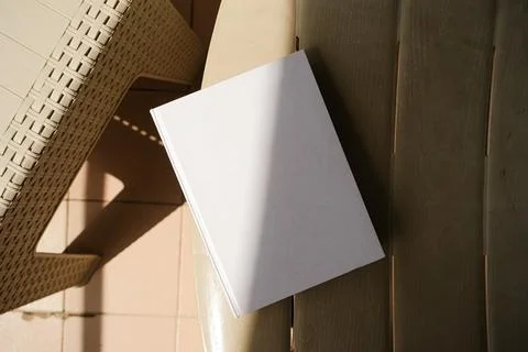 Empty book mockup on plastic table tile floor in the room, shadow overlay Stock Photos