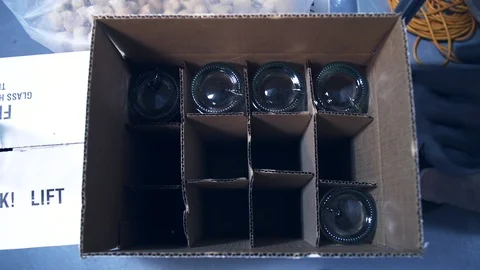 Empty booze bottles in supply box before during bottling process Video stock 87119105