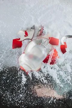 An empty bottle with a broken New Year's toy Stock Photos