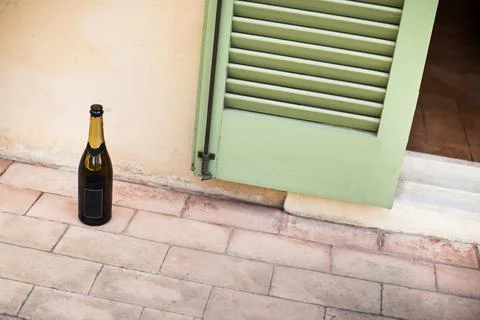 Empty bottle of champagne on the floor Stock Photos