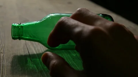 Empty bottle hand wooden table hd footage nobody Stock Footage 104668854