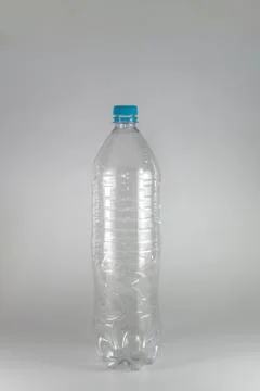 A empty  bottle of a liter and a half of mineral water with blue cap and seal Stock Photos