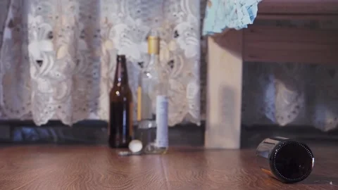 An empty bottle rolls on the floor Stock Footage 155494036