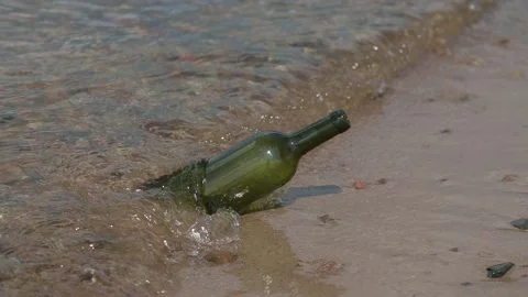 Empty bottle in the water by the sea Stock Footage 105960035