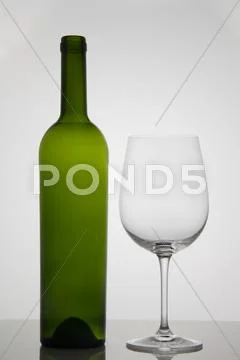 Empty bottle of wine with empty glass of wine on white background Stock Photos