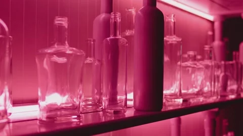 Empty bottles for alcohol drinks in shelves . Choosing bottles in wine factory Stock Footage 158707473