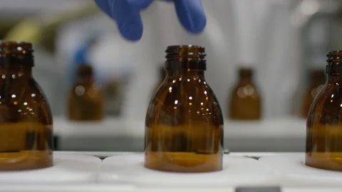 Empty bottles being inspected while moving on production line in factory Stock Footage 107984065