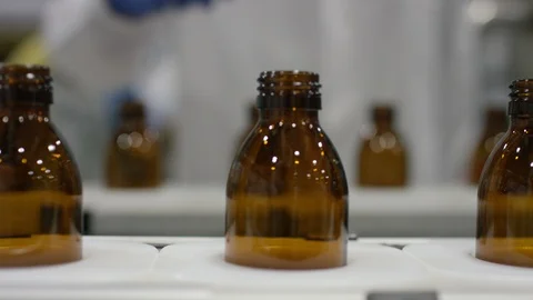 Empty bottles being inspected while moving on production line in factory Stock Footage 107984582