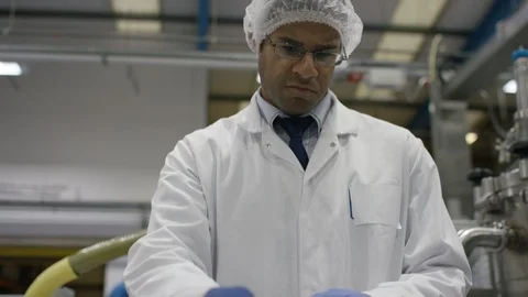 Empty bottles being inspected while moving on production line in factory Stock Footage 107984701