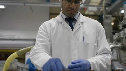 Empty bottles being inspected while moving on production line in factory Stock Footage 107985064