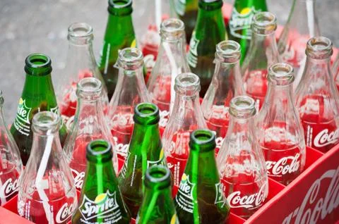 Empty bottles of coca cola and sprite Stock Photos
