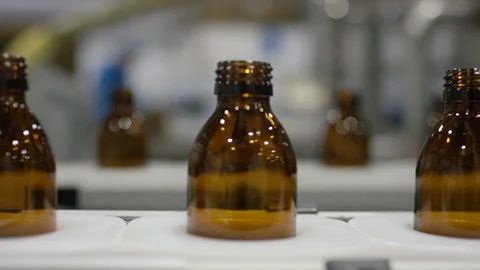 Empty bottles moving on production line in cosmetic factory Stock Footage 107983549