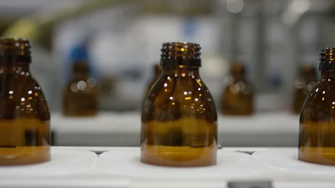 Empty bottles moving on production line in cosmetic factory Stock Footage 107983557