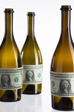 Empty bottles of wine from the label of dollar bill 库存照片