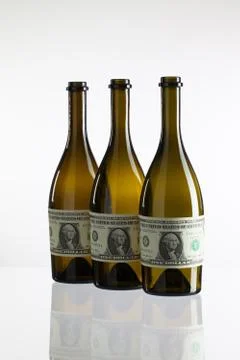 Empty bottles of wine from the label of dollar bill Fotos de archivo