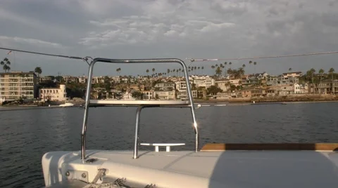 Empty bow chair on a catamaran moving through harbor on a cloudy afternoon.mp Stock Footage