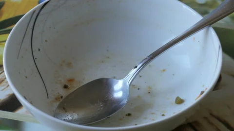 Empty bowl and spoon after eating. Finished eating.  Stock Footage 149989418