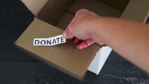Empty box with Donate label for second-hand items to be given away, charity d Video stock 148127654