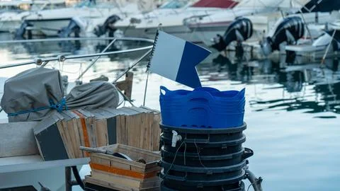 Empty boxes on a fishing boat lying in the harbor Stock Photos
