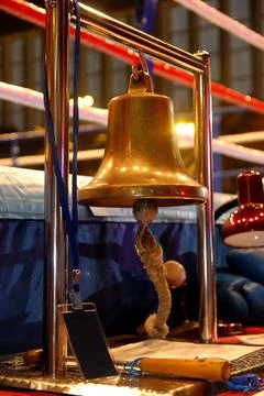 Empty boxing ring and bell Brass Boxing Bell Suspended on Metal Frame (Lic... Stock Photos