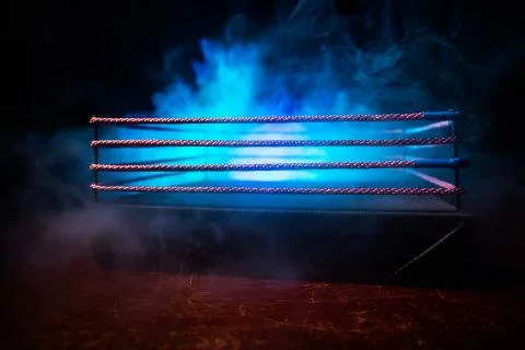 Empty boxing ring with red ropes for match in the stadium arena. Creative art Photos
