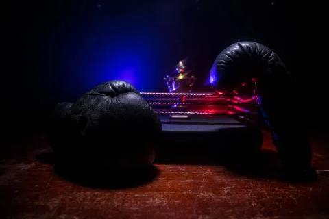 Empty boxing ring with red ropes for match in the stadium arena. Creative art Photos