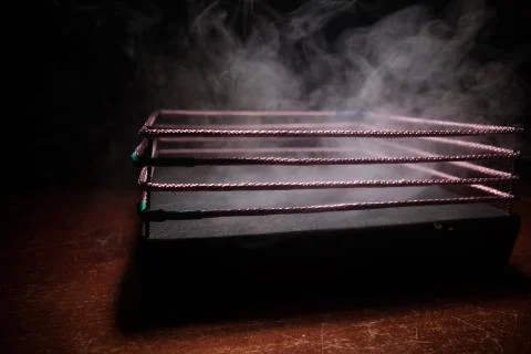 Empty boxing ring with red ropes for match in the stadium arena. Creative art Photos