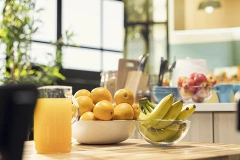 Empty breakfast table, kitchen with fruits and orange juice, breakfast meal Stock Photos