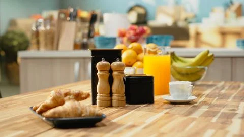 Empty breakfast table in a modern kitchen featuring croissants on plate Stock Photos