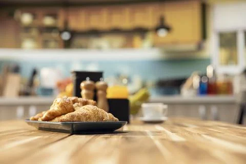 Empty breakfast table in a modern kitchen featuring croissants Stock Photos
