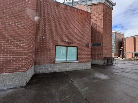 Empty brick ticket booth and admission window outside a stadium Stock Photos
