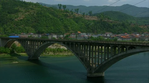 Empty bridge over river with beautiful green mountains Stock Footage 88824069