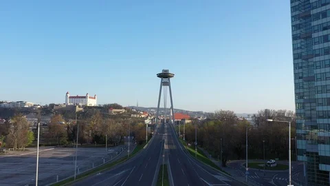 Empty bridge SNP in Bratislava,flying towards city centre and castle,lens flare Stock Footage