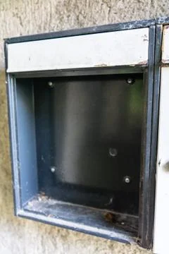 Empty broken mailbox from run down building Stock Photos