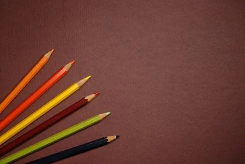 Empty brown cardboard background and coloured pencils - art utensil Stock Photos