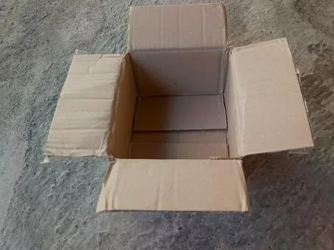 Empty Brown Cardboard Box Open Top View on Concrete Floor Stock Photos