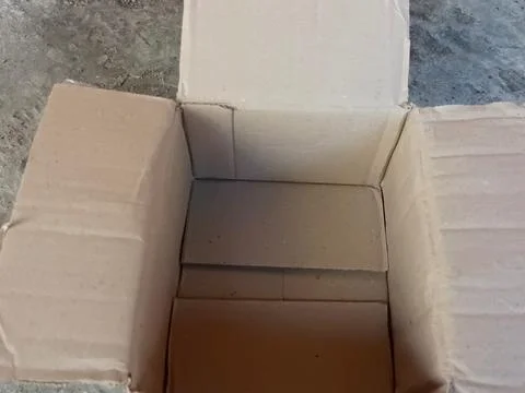 Empty Brown Cardboard Box Open Top View on Concrete Floor Stock Photos
