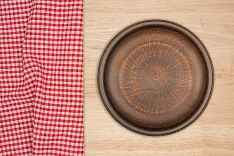 Empty brown ceramic plate on rustic wooden background Stock Photos