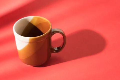 Empty brown cup on red table Foto stock