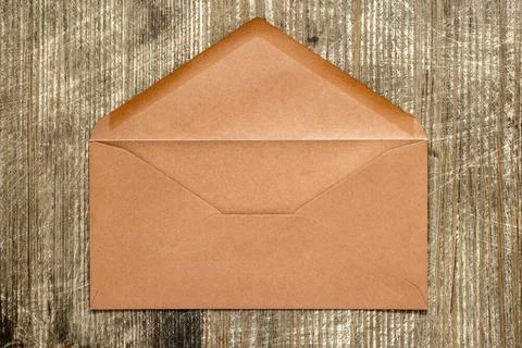 Empty brown envelope Open brown envelope lying on wooden background Copyri... Stock Photos