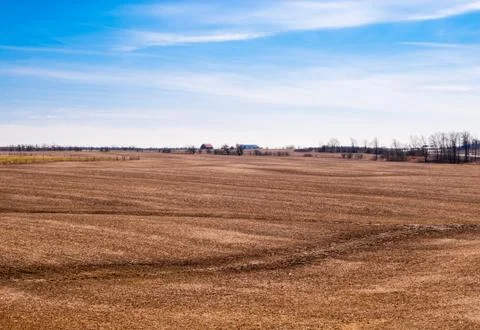 Empty brown farm fields on sky. Stock Photos