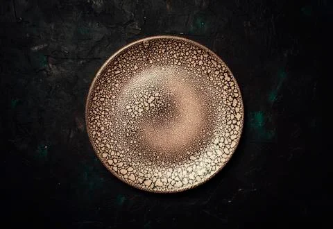 Empty brown plate on a dark background, top view Stock Photos